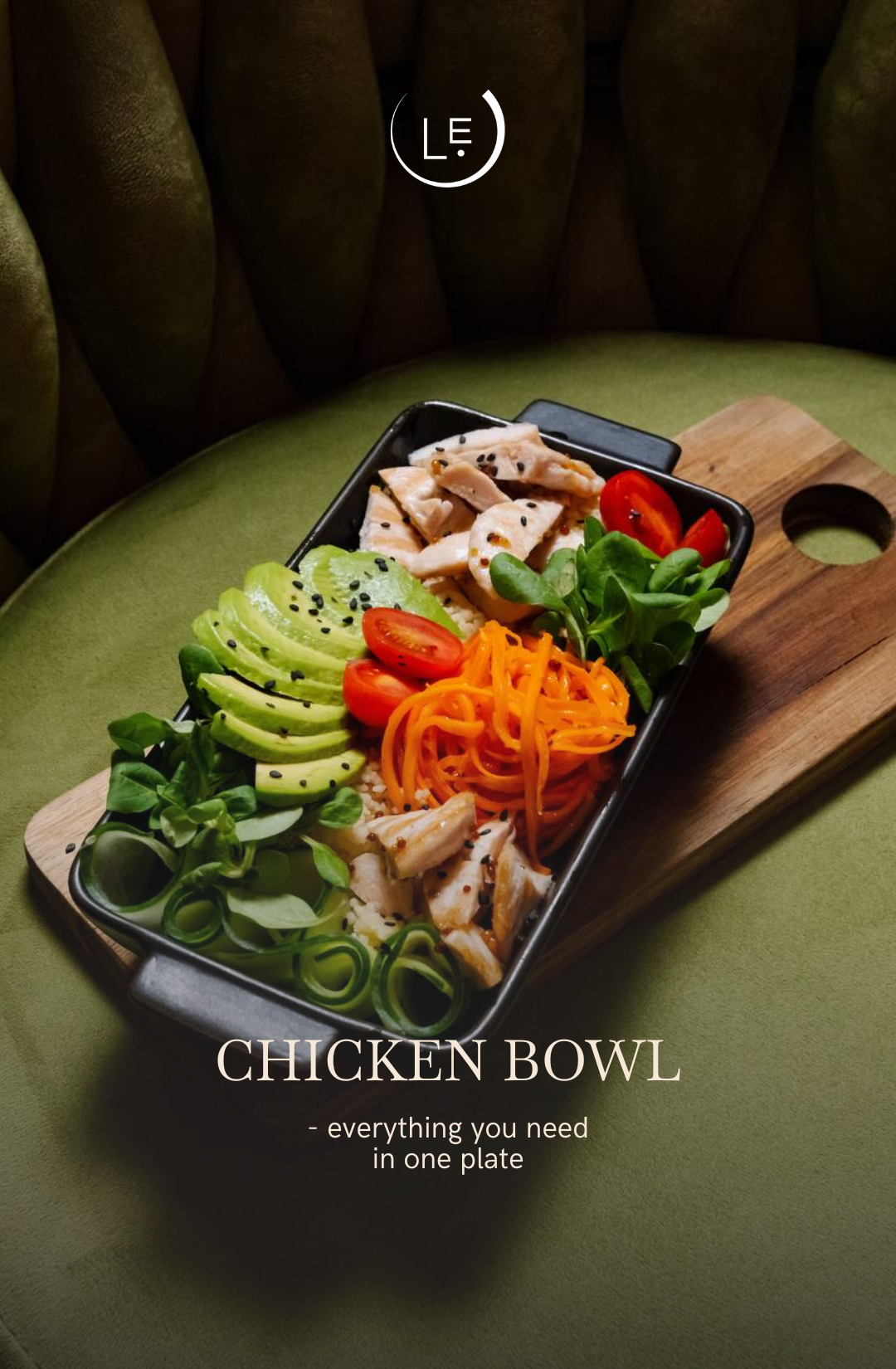 Chicken bowl with vegetables on a wooden board against a green background